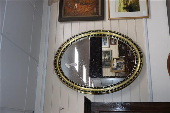 A pair of Irish style oval mirrors with glass-mounted gilt and ebonised frames H.105cm